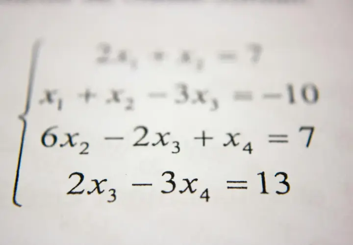 Układ równań liniowych z wyrażeniami algebraicznymi: 2x₁ + x₂ = 7, x₁ + x₂ - 3x₃ = -10, 6x₂ - 2x₃ + x₄ = 7, 2x₃ - 3x₄ = 13.
